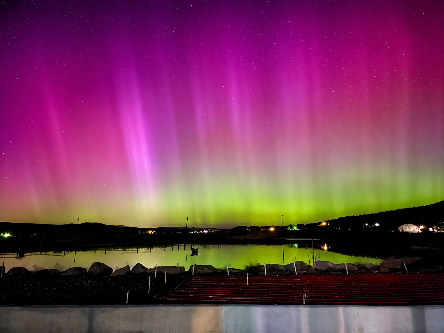 Northern lights and stars over the pond at Hunters Hot Springs Resort
